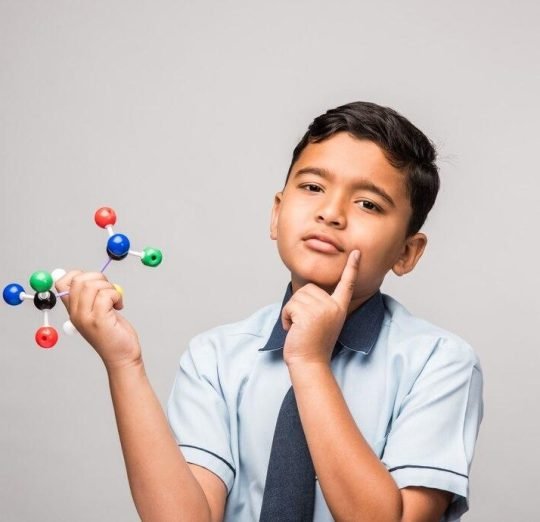 indian-school-kid-science-student-using-molecular-model-kit-studying-physics-selective-focus_466689-50218